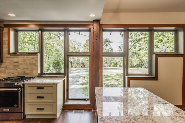 entryway featuring recessed lighting, visible vents, a wealth of natural light, and dark wood-type flooring