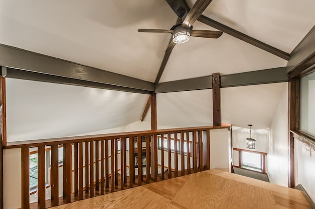 interior space featuring vaulted ceiling with beams and dark hardwood / wood-style flooring