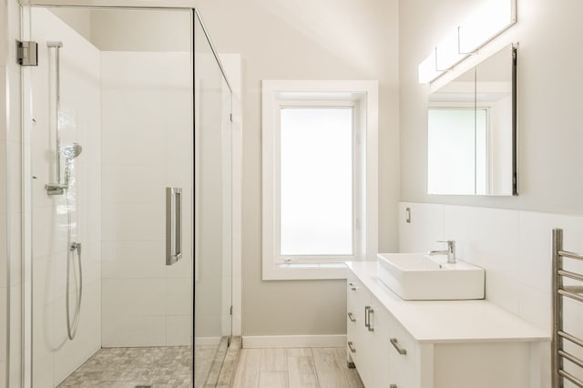 bathroom featuring wood-type flooring, vanity, and an enclosed shower