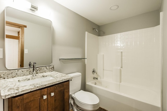 bathroom with shower / bathtub combination, toilet, and vanity