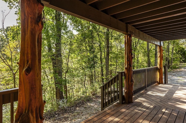 wooden terrace featuring a forest view