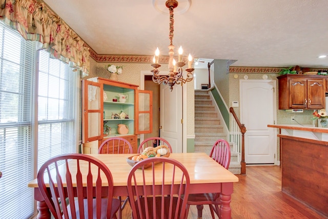 dining room featuring an inviting chandelier and light hardwood / wood-style flooring