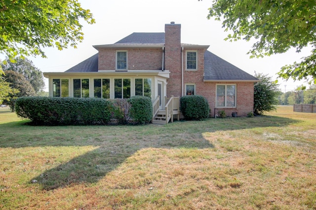 back of house with a lawn