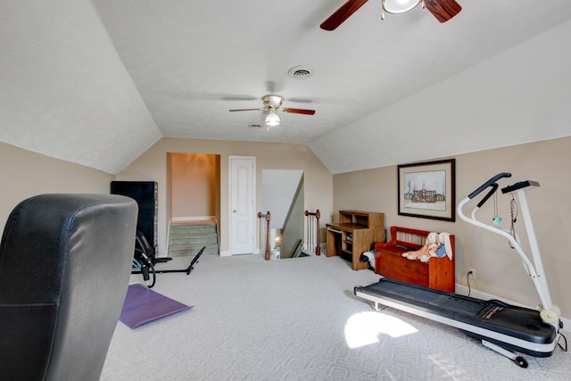 carpeted home office with ceiling fan and vaulted ceiling