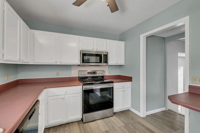 kitchen with stainless steel appliances, ceiling fan, light hardwood / wood-style flooring, and white cabinetry