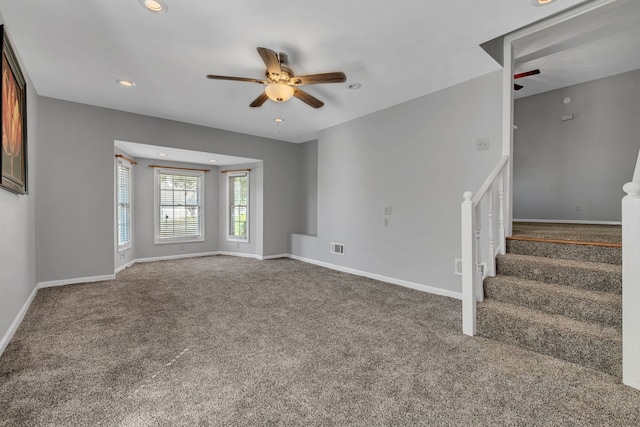 unfurnished living room featuring carpet and ceiling fan