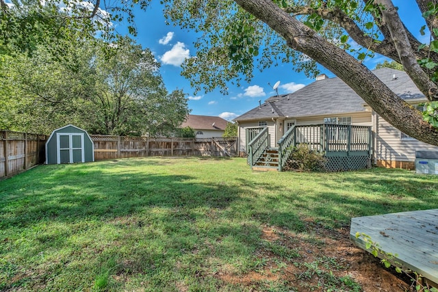 view of yard with a deck and a shed