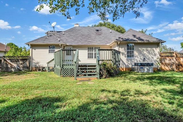 rear view of property with a wooden deck, a lawn, and central air condition unit