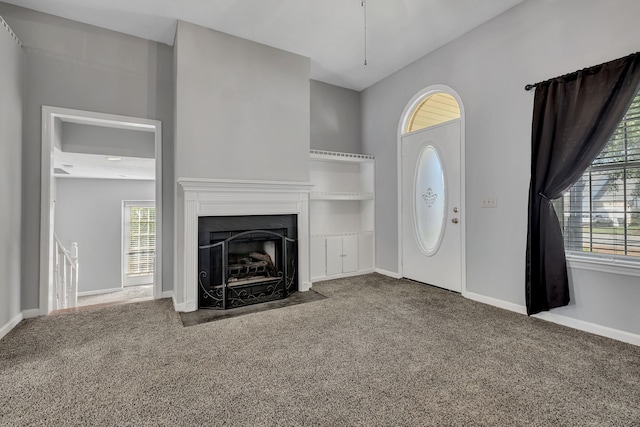 unfurnished living room featuring carpet flooring