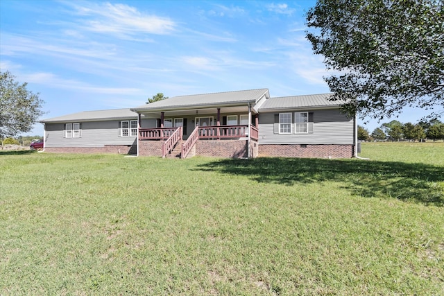 view of front of home featuring a front lawn and a deck