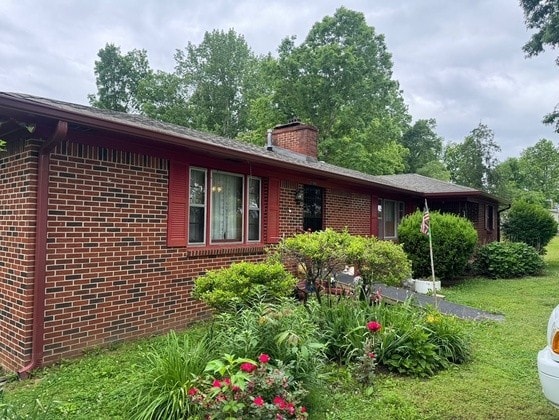 view of property exterior with a lawn