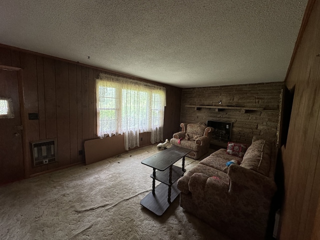 living room featuring a textured ceiling, a fireplace, wood walls, and heating unit