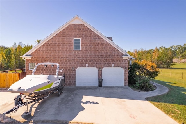 view of home's exterior with a garage and a lawn