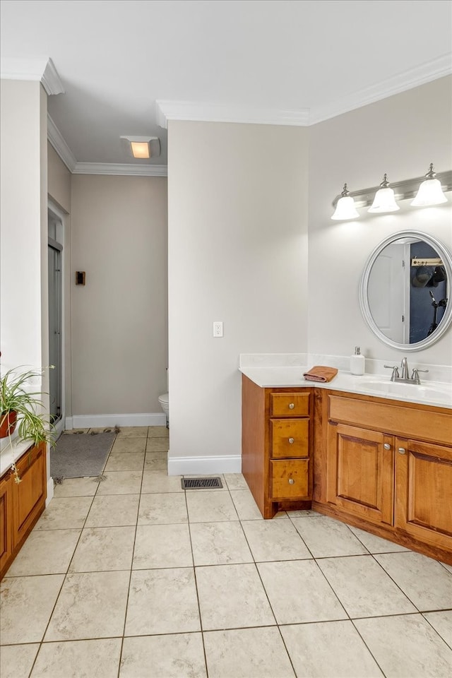 bathroom featuring tile patterned floors, crown molding, toilet, and vanity