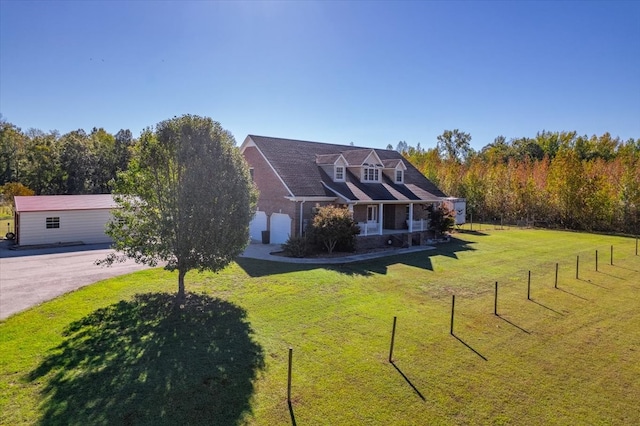 cape cod house featuring a front lawn