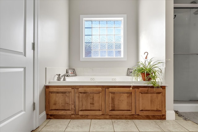 bathroom featuring tile patterned flooring and shower with separate bathtub