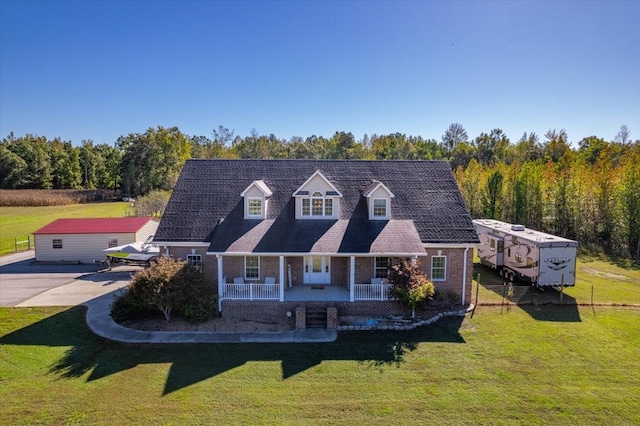 cape cod-style house with a front lawn and covered porch