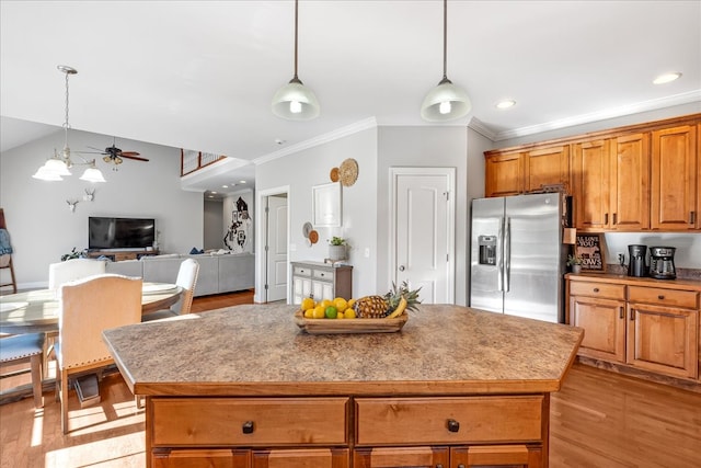 kitchen with ceiling fan, light hardwood / wood-style floors, stainless steel fridge with ice dispenser, and a center island