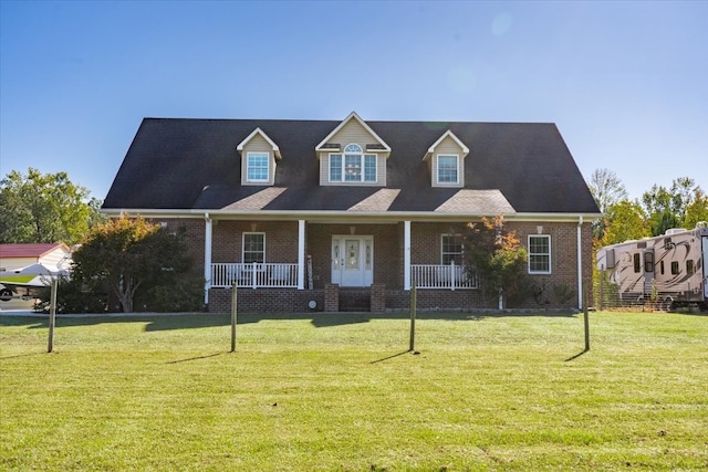 cape cod-style house featuring a porch and a front yard