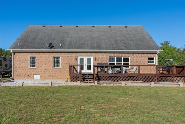 rear view of property with a deck and a yard