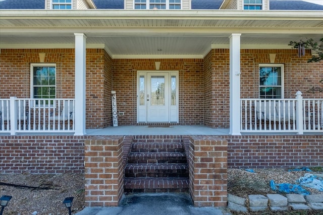 doorway to property featuring covered porch