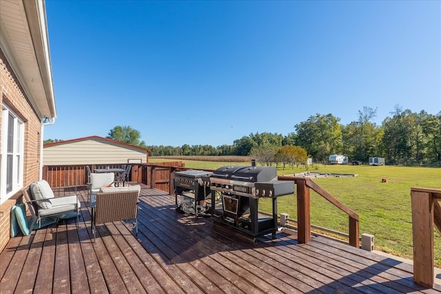 deck featuring a yard and grilling area