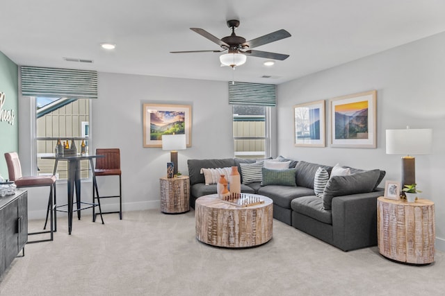 living room featuring light carpet and ceiling fan