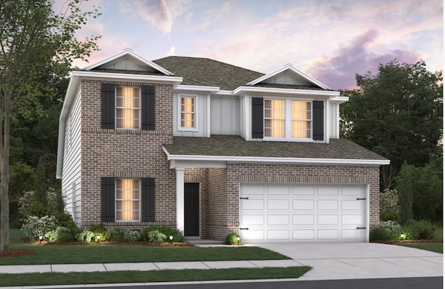 view of front of home featuring a garage and a yard