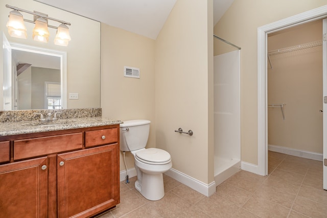 bathroom featuring a shower, toilet, vaulted ceiling, tile patterned floors, and vanity