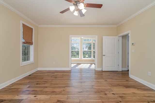 spare room with ceiling fan, light wood-type flooring, and ornamental molding