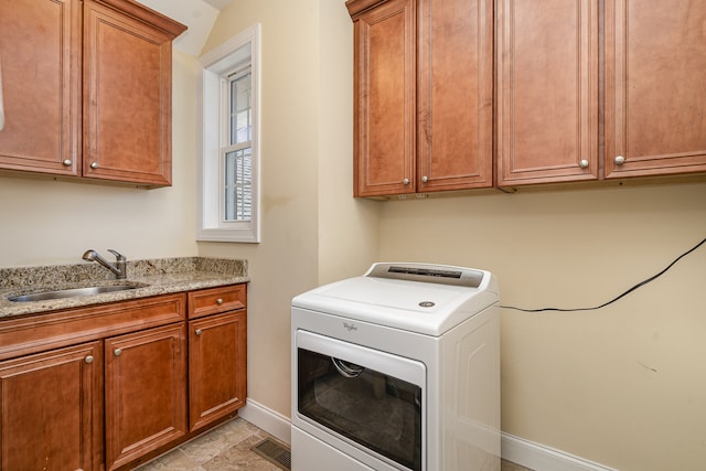 laundry area with cabinets, sink, and washer / dryer