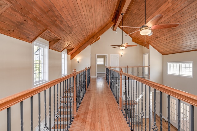 hall with wooden ceiling, beam ceiling, light hardwood / wood-style flooring, and high vaulted ceiling