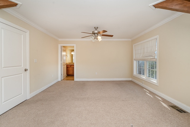 carpeted empty room featuring ceiling fan and crown molding