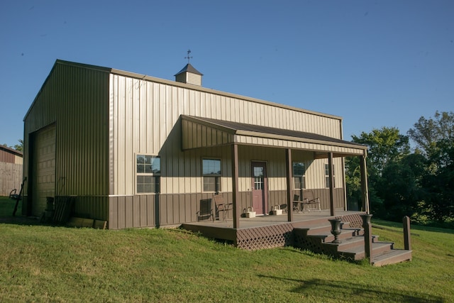 back of property featuring a yard and a porch