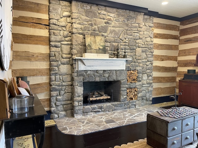 living room with hardwood / wood-style flooring, a fireplace, and wood walls