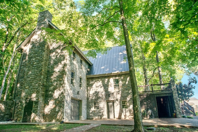 view of side of home with a patio and a deck