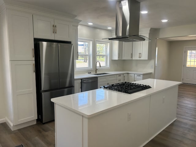 kitchen with a healthy amount of sunlight, island exhaust hood, appliances with stainless steel finishes, and white cabinets