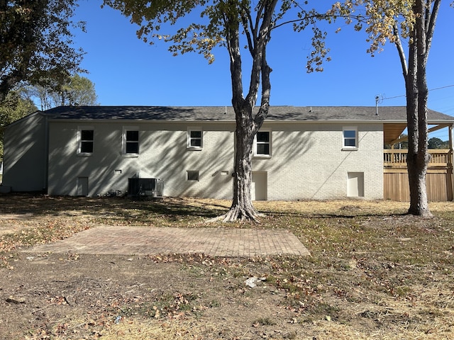 rear view of house featuring central air condition unit