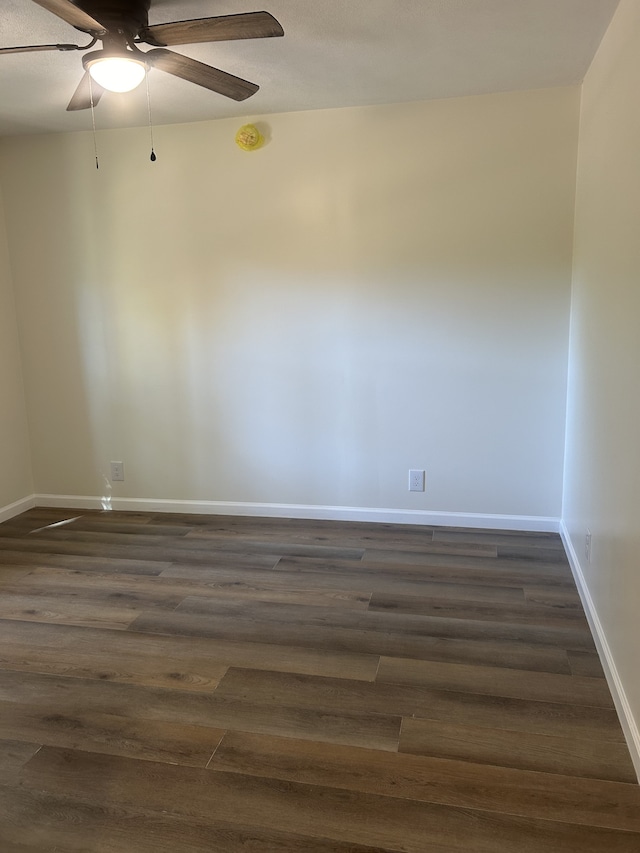 spare room with ceiling fan and dark hardwood / wood-style flooring