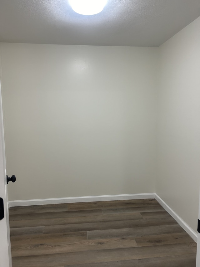 spare room with dark hardwood / wood-style flooring