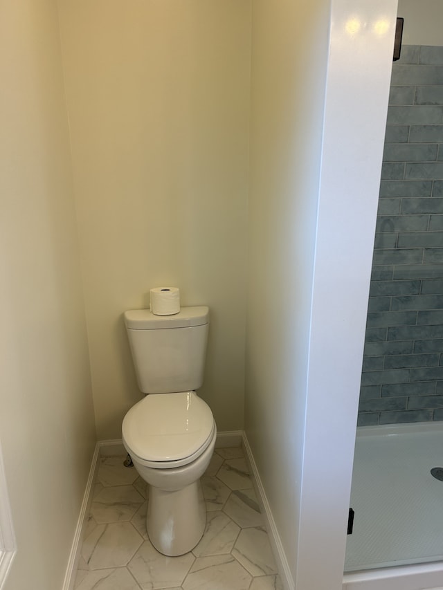 bathroom with toilet and walk in shower