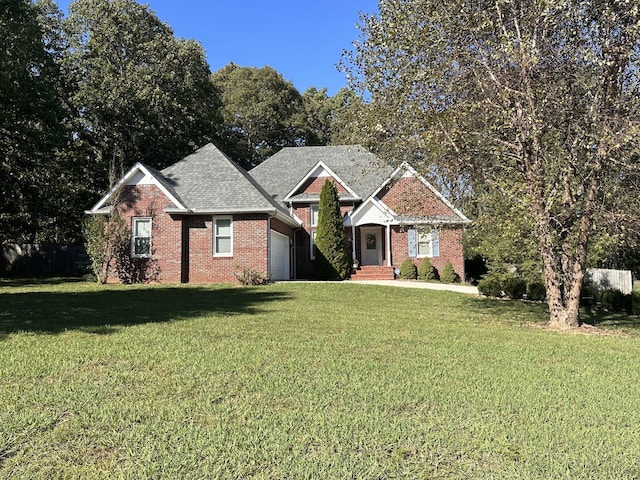 view of front facade with a front yard and a garage