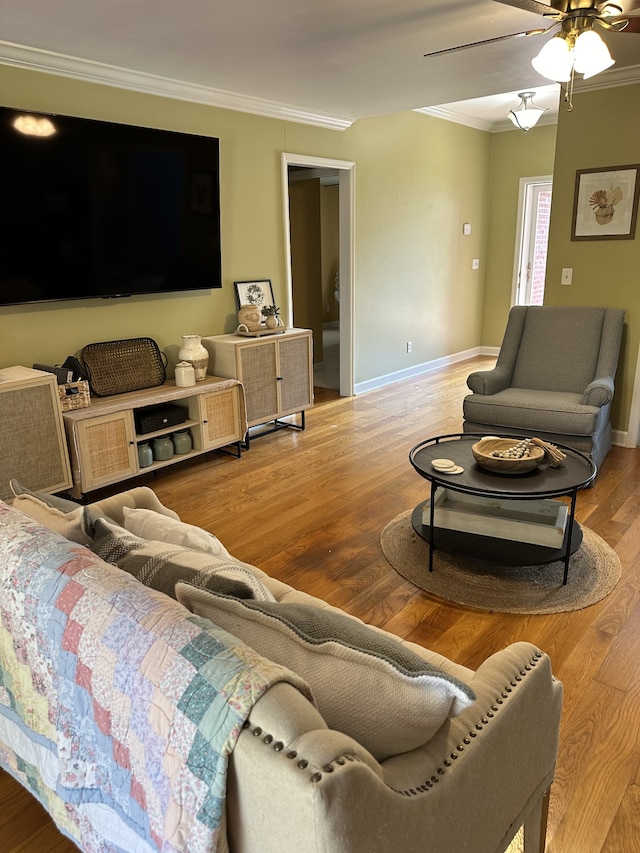 living room with ornamental molding, hardwood / wood-style floors, and ceiling fan