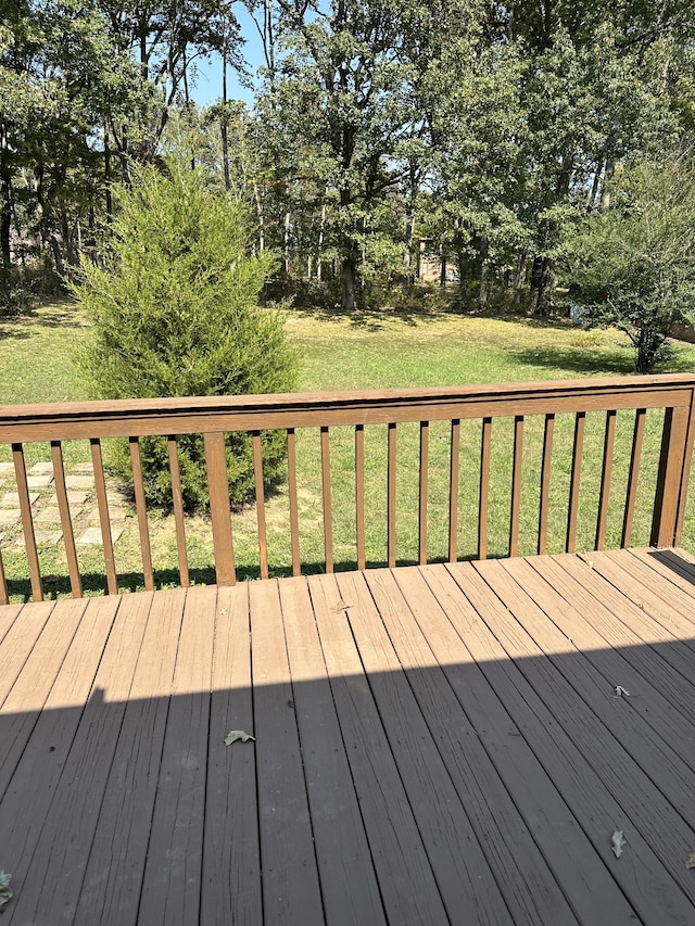 wooden terrace with a lawn