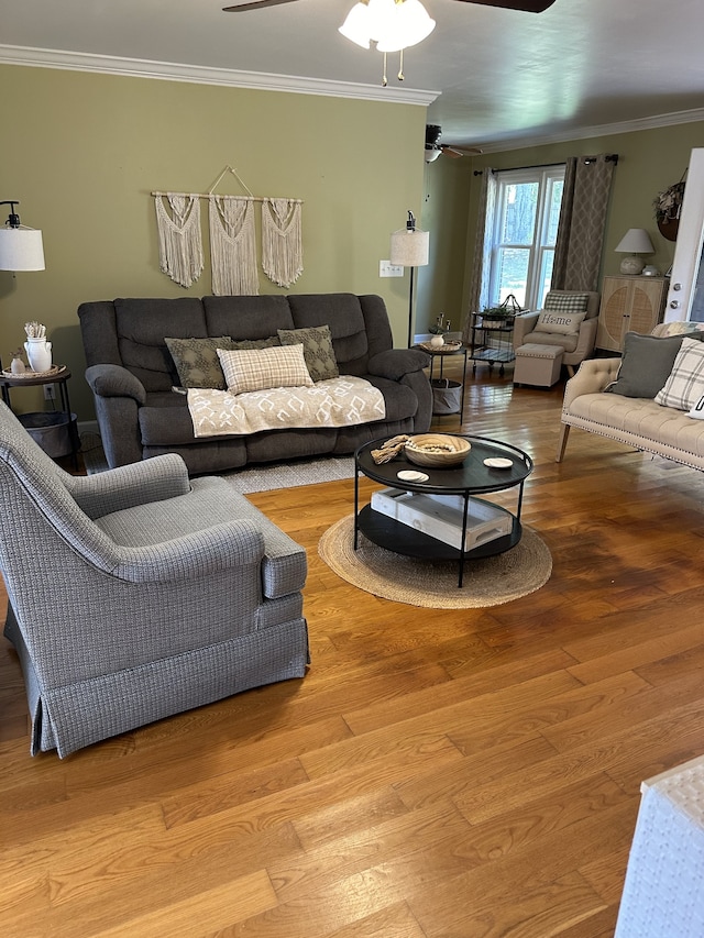 living room with wood-type flooring, crown molding, and ceiling fan