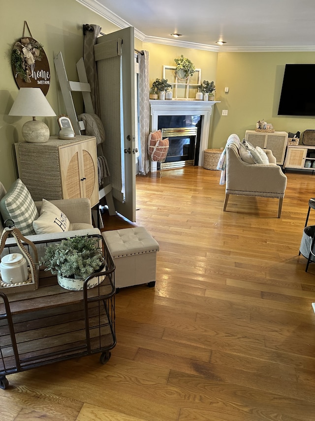 living room featuring light hardwood / wood-style flooring and ornamental molding