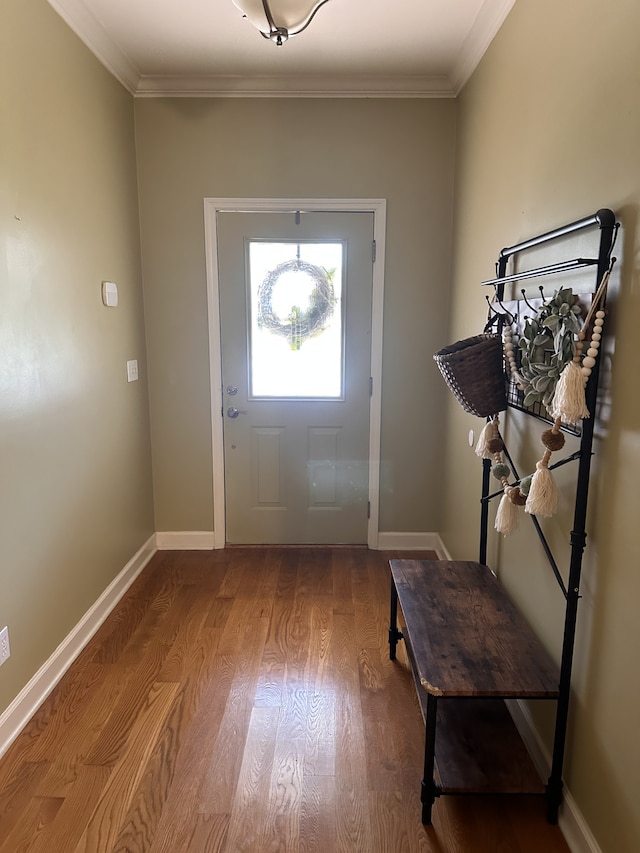 foyer entrance featuring hardwood / wood-style flooring and crown molding