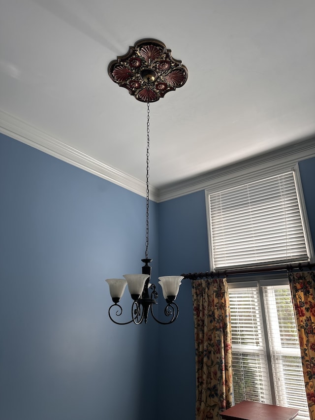 room details with ornamental molding and a notable chandelier