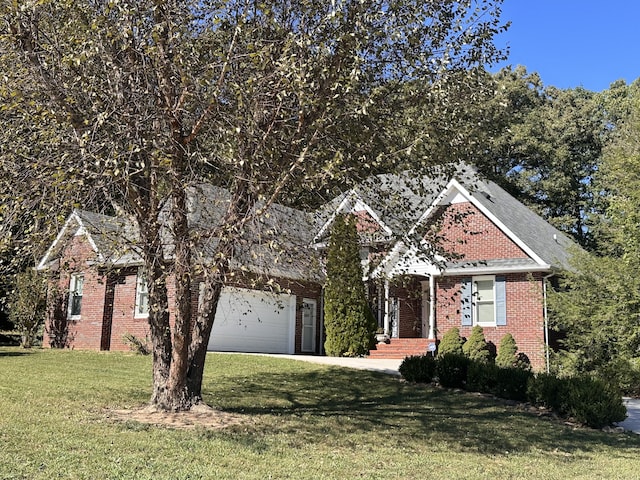 view of property hidden behind natural elements featuring a front lawn and a garage