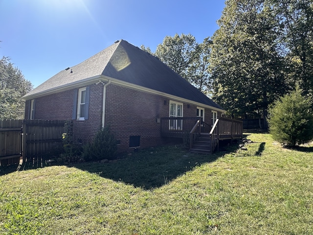 view of property exterior featuring a yard and a wooden deck